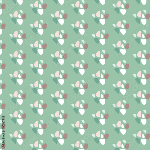 colorful pebbles repeat pattern on green background.