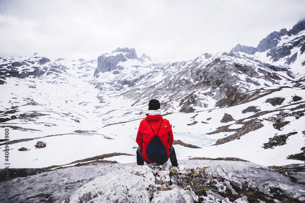  	Man alone siting looking to the mountains