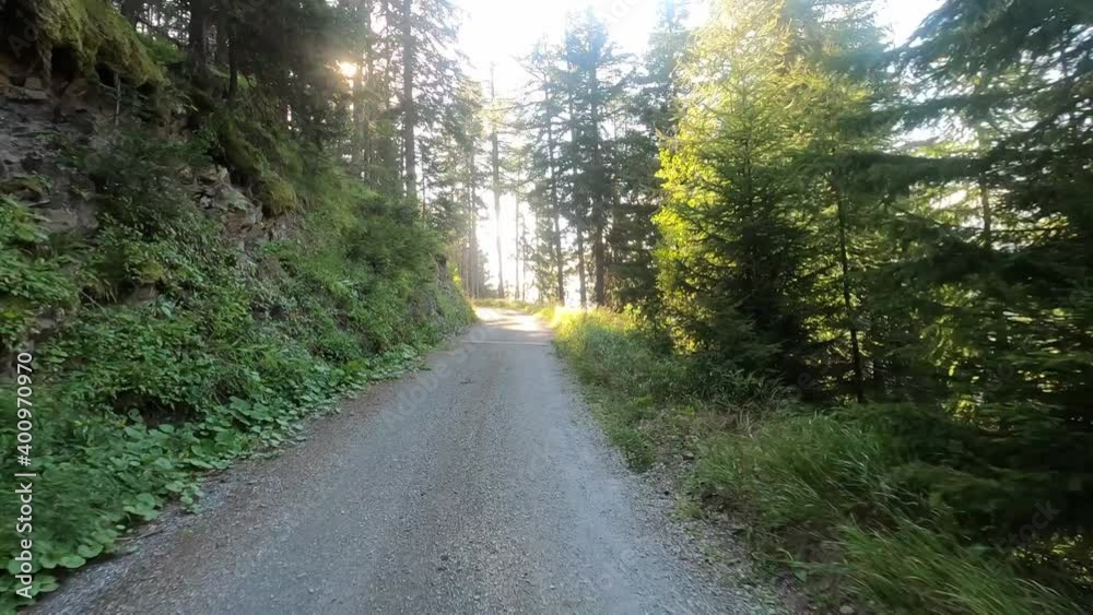 Dangerous mountain road with an offroad without asphalt. Mountains, natural road and trees are in the picture Dangerous mountain road with an offroad without asphalt. Mountains, natural road and trees are in the picture