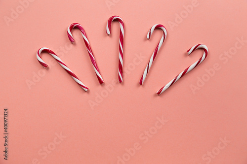 Top view of Christmas many candy cane on pastel pink background.Holiday festive celebration greeting card with copy space to addng text photo