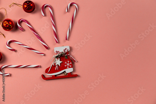 Top view of Christmas bells with many candy cane on pastel pink background.Holiday festive celebration greeting card with copy space to addng text photo