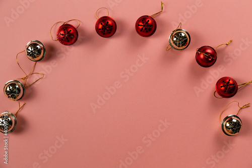 Top view of Christmas bells with many candy cane on pastel pink background.Holiday festive celebration greeting card with copy space to addng text photo