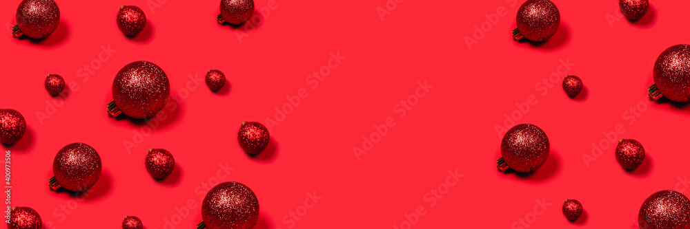Minimalistic bright composition. Christmas festive banner with red toys and place for text in center. Minimalistic bright composition. Christmas festive banner with red toys and place for text in center.