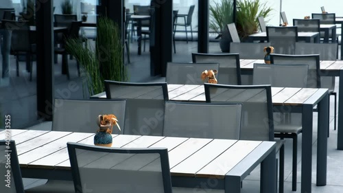 Close up shot of empty tables and chairs in the restaurant. Restaurants are closed due to covid-19 epidemic.	