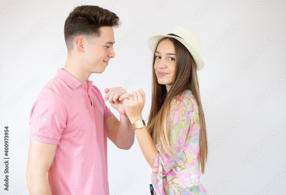 Happy loving couple holding hands over white background Happy loving couple holding hands over white background