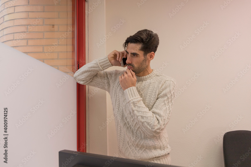 man talking on the phone in an office man talking on the phone in an office