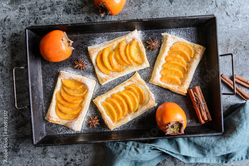 Persimmon puff pastry pies with cinnamon