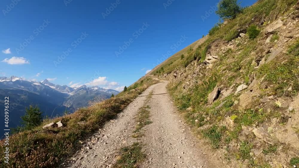 Mountain road with an offroad without asphalt. Mountains, natural road and trees are in the picture Mountain road with an offroad without asphalt. Mountains, natural road and trees are in the picture
