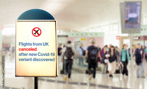 a sign inside an airport warns of the cancellation of flights form UK after new Covid-19 variant discover