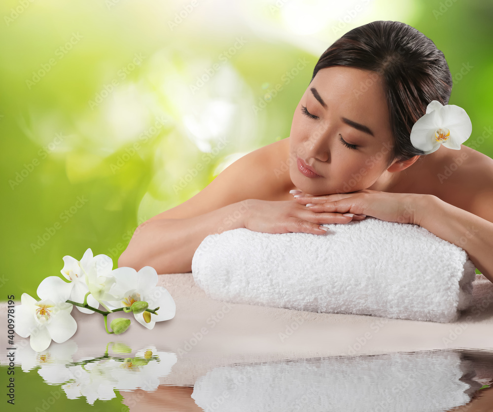Beautiful Asian woman lying on massage table. Spa treatment Beautiful Asian woman lying on massage table. Spa treatment