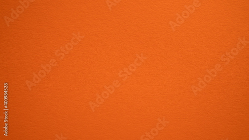 Orange color wall texture background. Carrot color texture backdrop design. Amber, pumpkin, halloween backdrop
