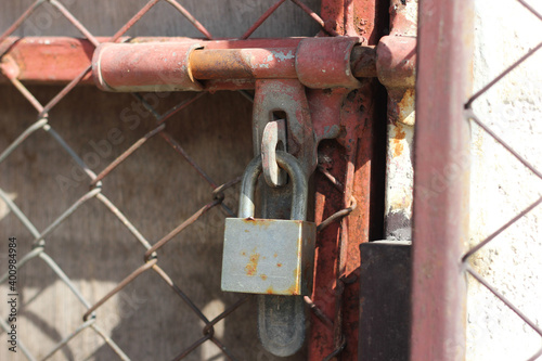 close up rusty locks iron door or steel door in building to prevent thieves. Security concept.