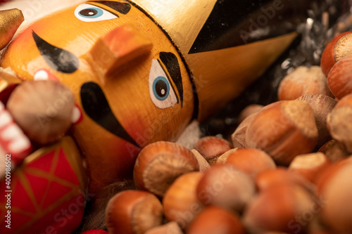 Wooden figure in the form of a soldier for chopping nuts and hazelnuts in bulk. It's time for the autumn harvest. Close-up, selective focus.