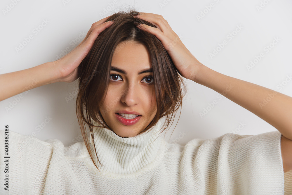 Cozy. Portrait of beautiful brunette woman in comfortable soft longsleeve isolated on white studio background. Home comfort, emotions, facial expression, winter mood concept. Copyspace. Cozy. Portrait of beautiful brunette woman in comfortable soft longsleeve isolated on white studio background. Home comfort, emotions, facial expression, winter mood concept. Copyspace.