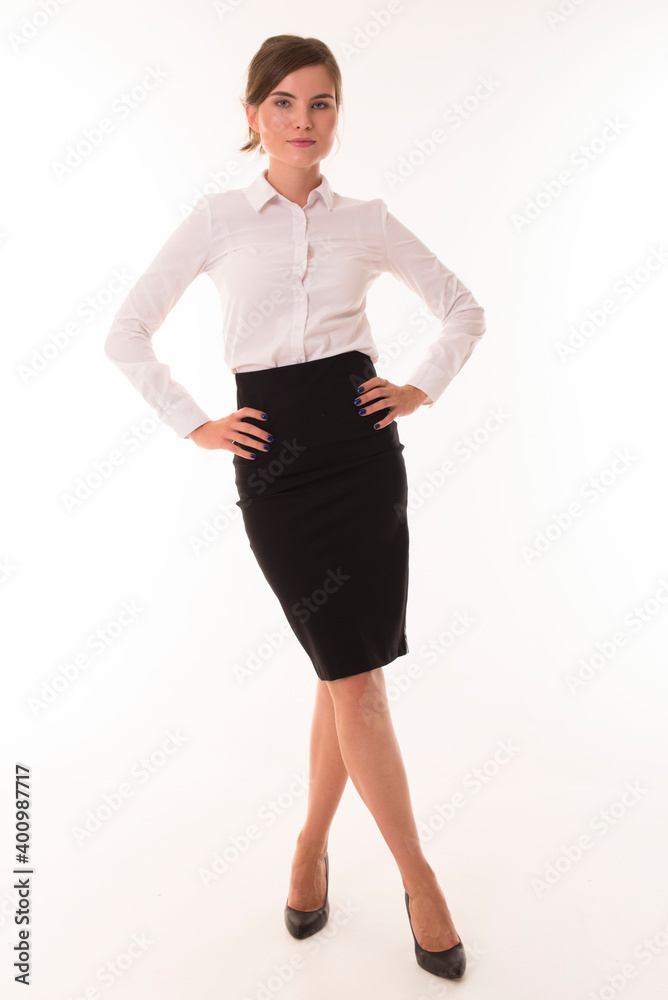 Brunette posing on a white in a skirt and shirt. Brunette posing on a white in a skirt and shirt.