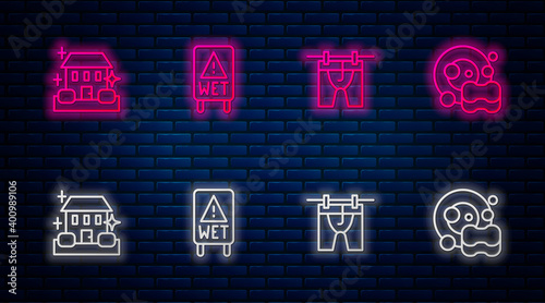 Set line Wet floor, Drying clothes, Home cleaning service and Washing dishes. Glowing neon icon on brick wall. Vector.