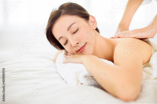 relaxed Young woman enjoy massage in spa salon