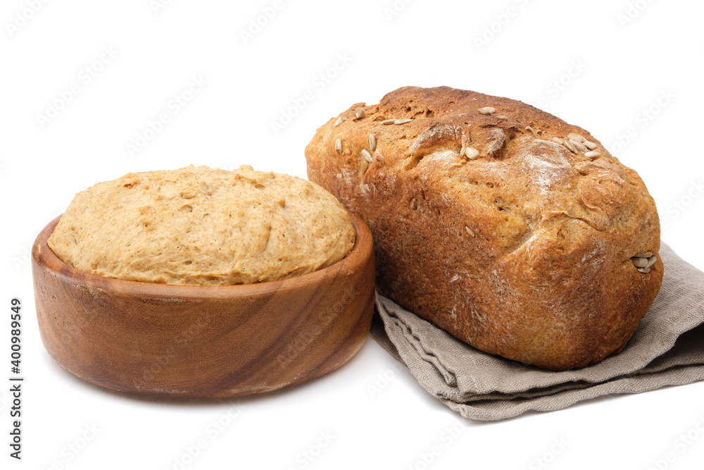 Wooden bowl of dough and freshly baked loaf on white. Wooden bowl of dough and freshly baked loaf on white.