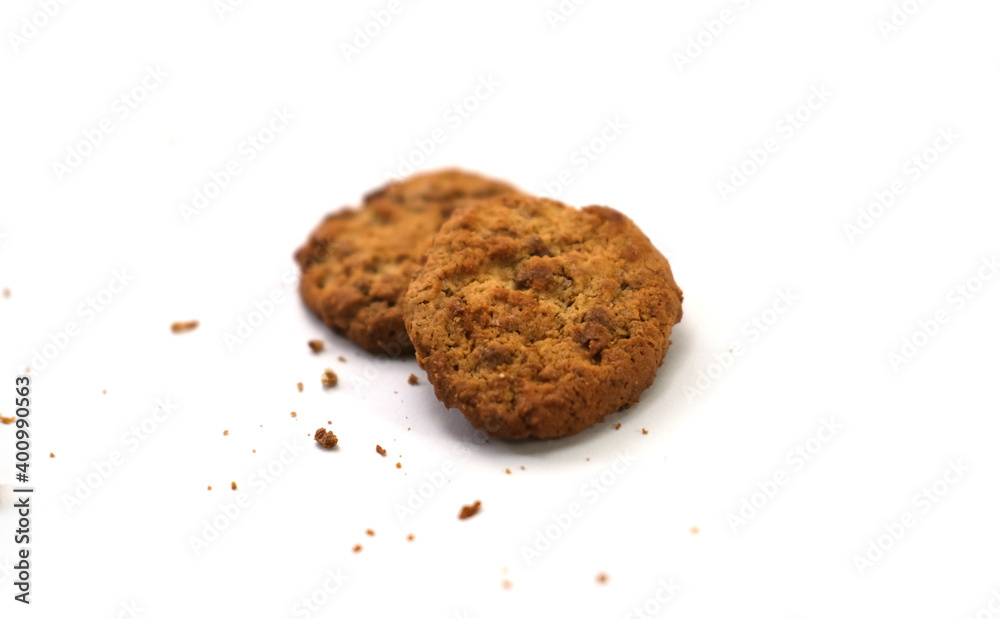 Raisin-topped circle cookies with cookie powder scattered around, isolated on a white background