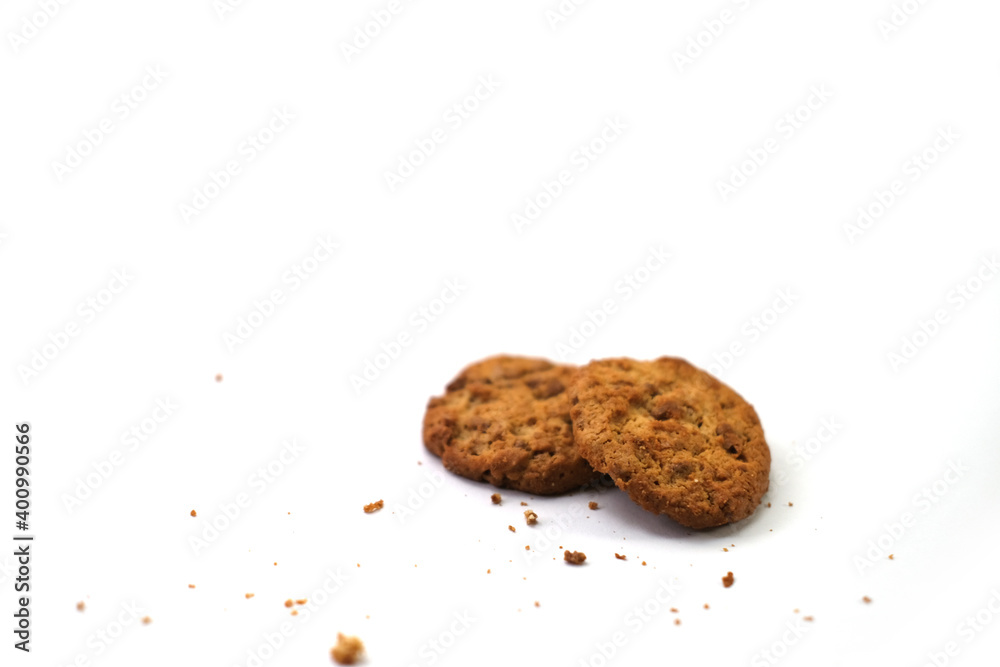 Raisin-topped circle cookies with cookie powder scattered around, isolated on a white background Raisin-topped circle cookies with cookie powder scattered around, isolated on a white background