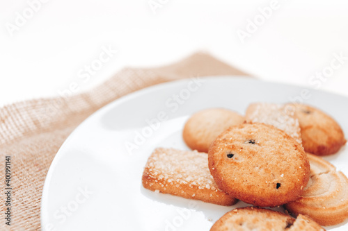 Butter cookies in a white plate on a white background.