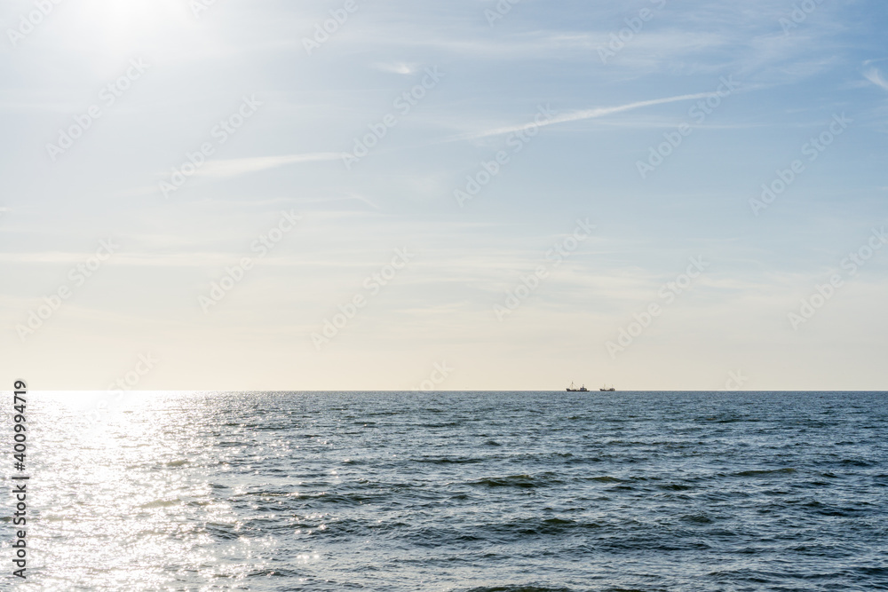 Obraz premium 2 fishing boats on the north sea during sunset in front of the Dutch coast near the island of Texel. 