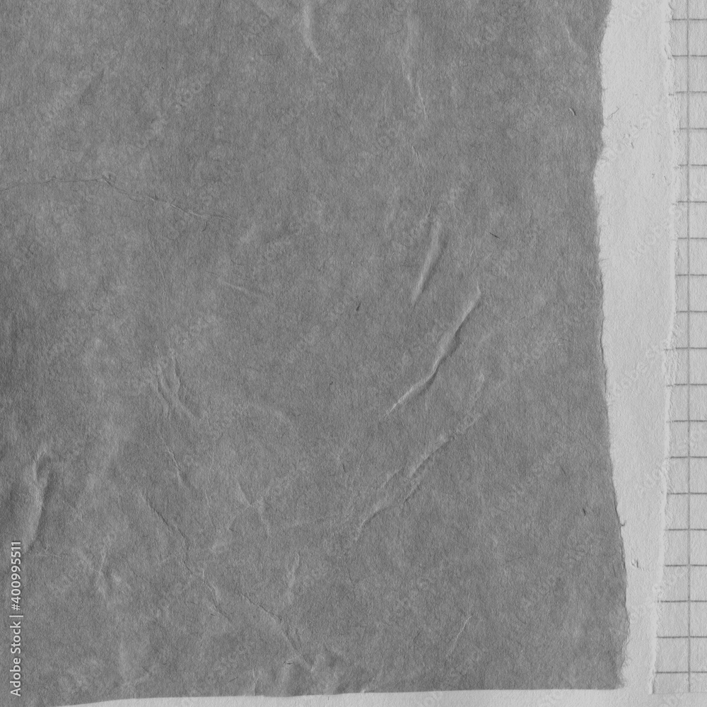 Fototapeta premium Black torn paper collage close-up. Texture made from various paper and cardboard parts. Damaged old paper background. Vintage blank wallpaper. Material design backdrop.