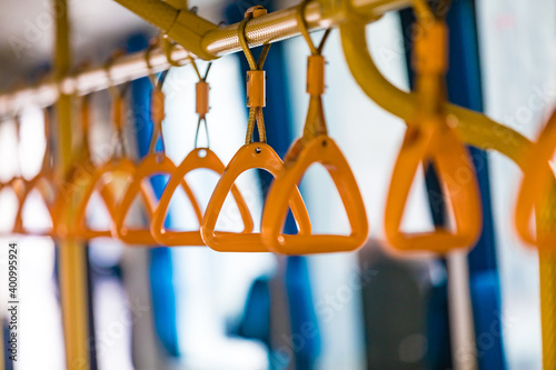 Row of orange grab safety straps handles inside shuttle bus