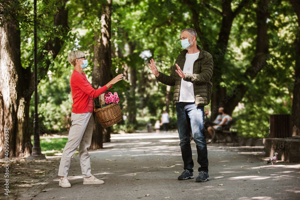 Obraz premium Senior people together in times of coronavirus social distancing in the park. New normal.
