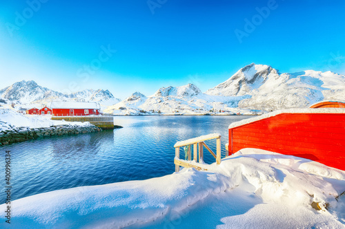 Traditional Norwegian red wooden houses on the shore of  Sundstraumen strait photo