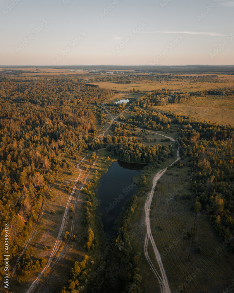 aerial landscape of forest lake and sunset sky