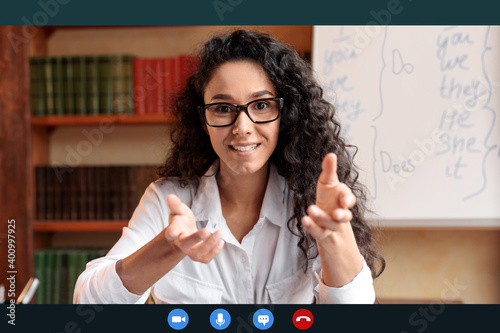 Female english teacher explaining lesson, talking to camera