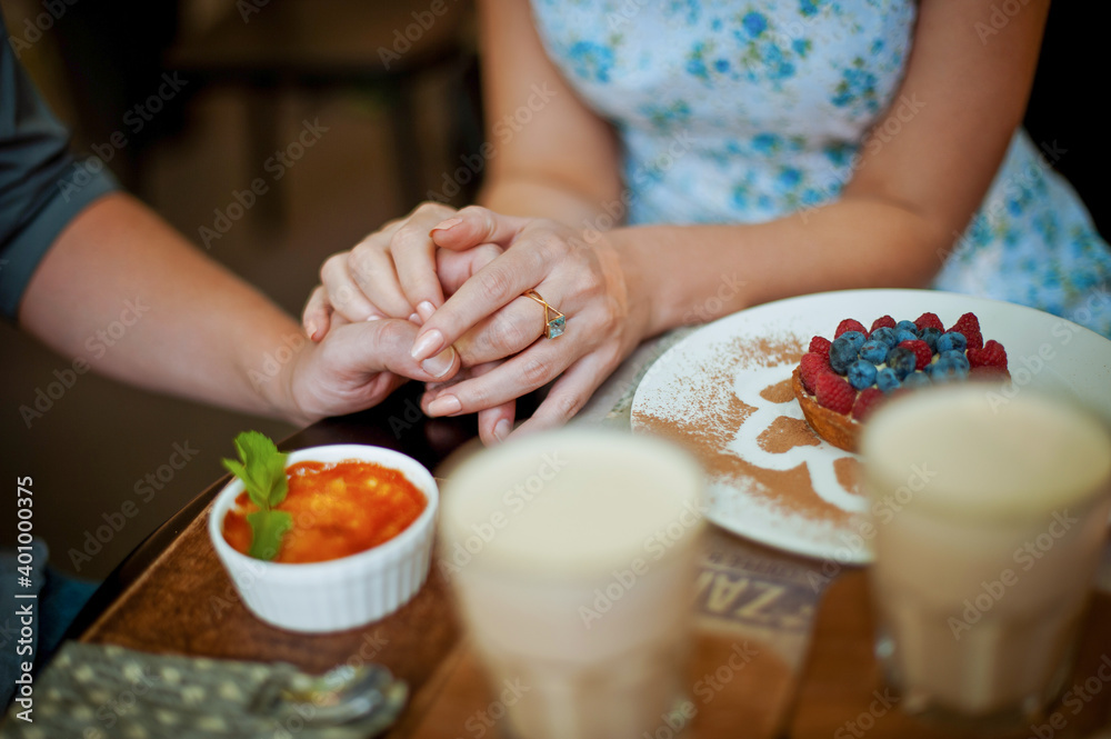 Couple holding hands in a cafe for a romantic lunch