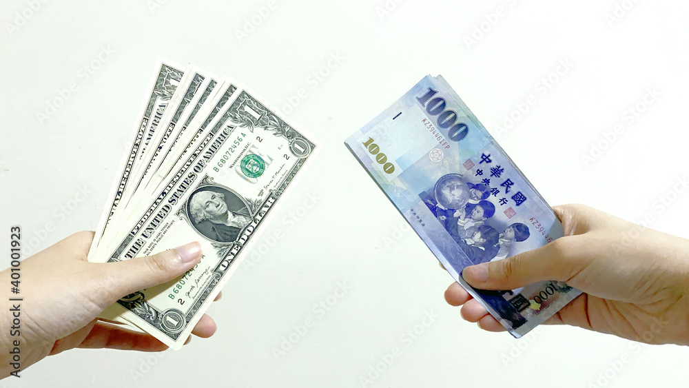 Money changing hands of people. Taiwan one-thousand-dollar exchange US one-dollar money. Concept for current exchange rate, foreign currency exchange. Money changing hands of people. Taiwan one-thousand-dollar exchange US one-dollar money. Concept for current exchange rate, foreign currency exchange.