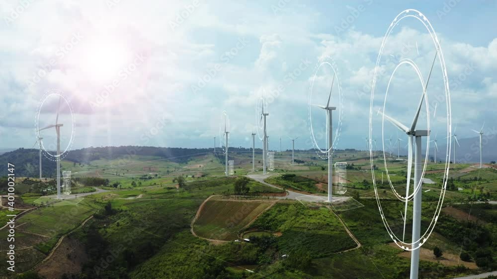 Aerial view of windmills with digitally generated holographic display tech data visualization. Wind power turbines generating clean renewable energy for sustainable development in a green ecologic way