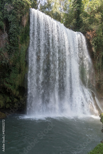 Vertical shot of the waterfalls in the historical garden park of the Stone Monastery in Nuevalos