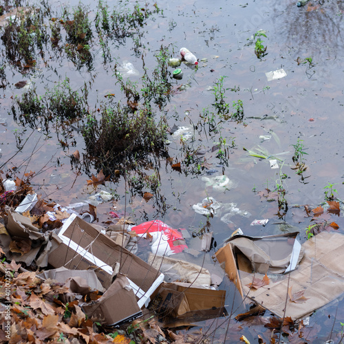 Trash thrown away in water, environmental problems. Nature disaster concept