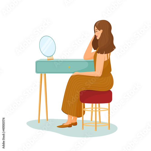 Young woman sits at the dressing table and looks in the mirror. Girl in a striped skirt. Vector illustration on white background. primping hair. Morning routine, start day, everyday life. Flat cartoon