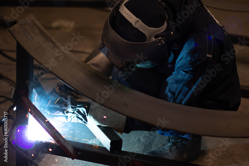 Metal workers use manual labor  Skilled welder  Factory workers making OT. Welder is welding the steel in the factory.