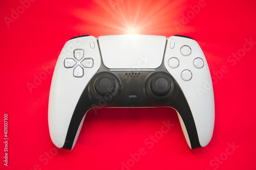 Video games white gaming controller joystick isolated on red color sky background, top view with copy space