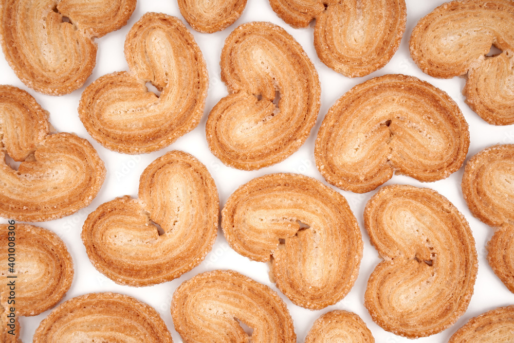 Puff pastry cookies. Fresh puff pastry cookies in the shape of a heart. Classic French pastries. Pig ear, elephant ear cookies, French hearts. Heart shaped puff pastry isolated on white background Puff pastry cookies. Fresh puff pastry cookies in the shape of a heart. Classic French pastries. Pig ear, elephant ear cookies, French hearts. Heart shaped puff pastry isolated on white background
