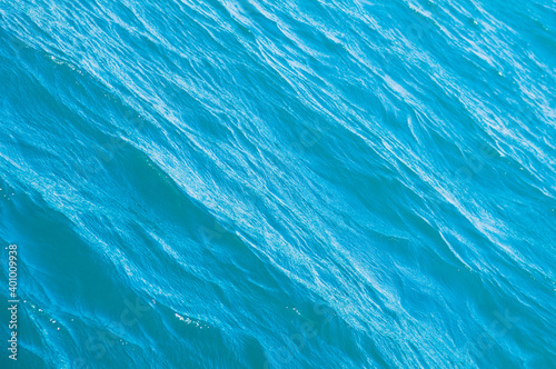 Blue sea surface background with waves. Silky texture of ocean water. Caribbean lifestyle themes