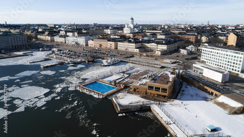 Aerial view of beautiful city in Europe. Ice floes in sea water. Helsinki, Finland. 