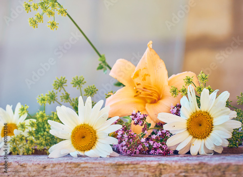 Summer flowers on a wooden background.