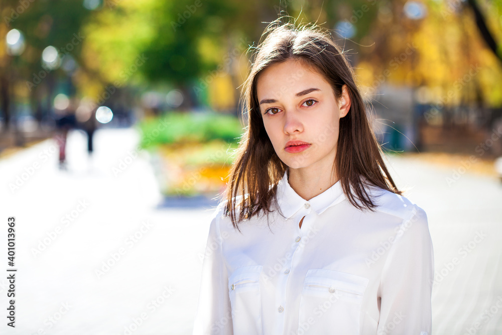 Close up portrait of a young brunette girl in white shirt Close up portrait of a young brunette girl in white shirt