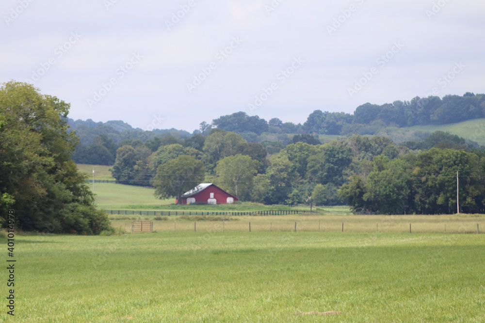 landscape with a barn in the background