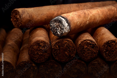 Tobacco cuban havana cigars romeo and julia burned with ash. Beautiful macro background in low key. © igradesign