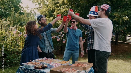 Friends making a toast at a 4th of July picnic