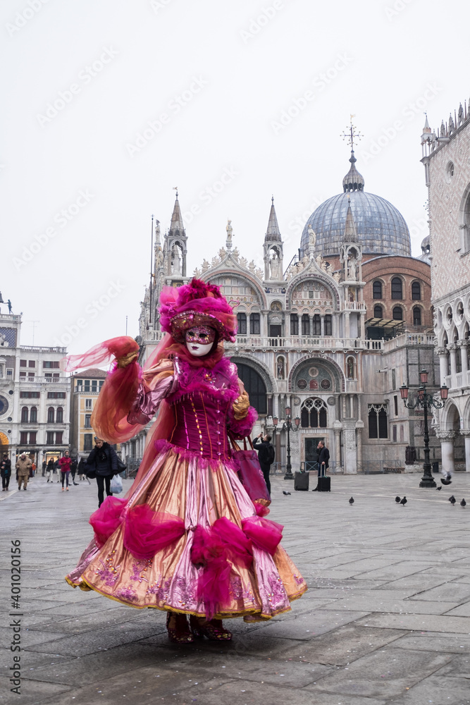 Venice, Italy - February 17, 2020: An unidentified woman in a carnival costume in Piazza San Marco attends at the Carnival of Venice.