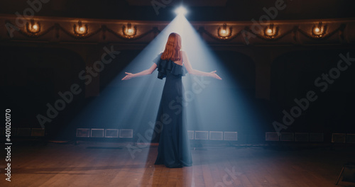 Young actress speaking passionately on stage